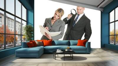 business man spying on business woman with magnifying glass Wall mural