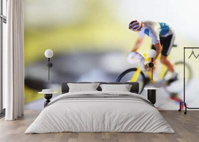 Miniature model of cyclist on bicycle scene. Wall mural