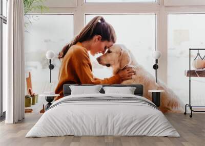 close up of beautiful woman hugging her adorable golden retriever dog at home. love for animals concept. lifestyle indoors Wall mural