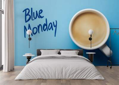 A coffee cup with a sad face on it and the words Blue Monday written below it Wall mural