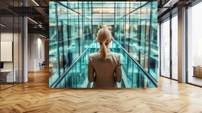 A woman in a business suit stands in a glass elevator Wall mural