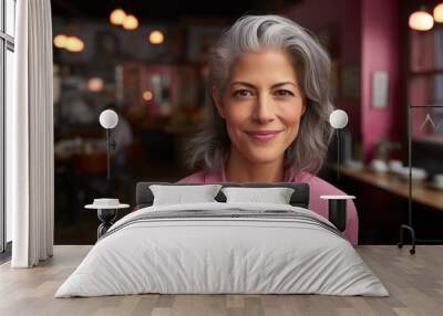 Attractive mature businesswoman looking at the camera with a quiet smile of satisfaction. Wall mural