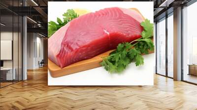 Fresh, raw tuna fish fillet with vibrant green parsley garnish, isolated on white background Wall mural