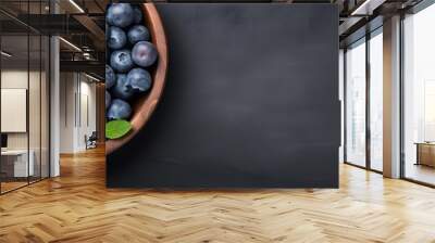 Fresh Blueberries in Wooden Bowl on Dark Background Wall mural