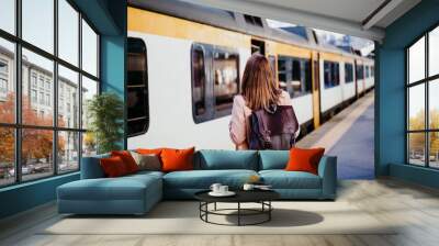 happy young woman walking at train station. travel concept Wall mural