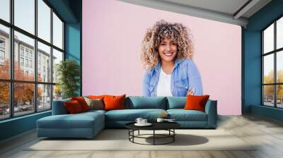 portrait of smiling hispanic woman with afro hair in city.spring. Arms crossed.Urban lifestyle Wall mural