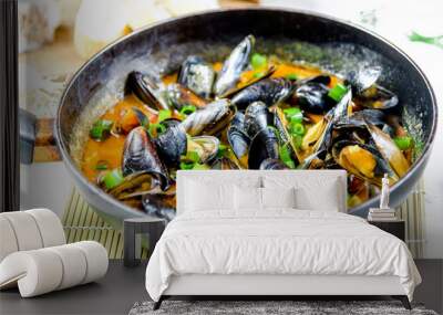 Delicious seafood mussels with red sauce and green onions in a pan Wall mural