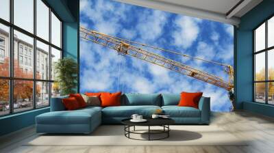 Tower crane detail with blue sky and clouds in the background on a construction site in Budapest, Hungary Wall mural