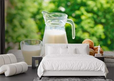 Jug and a glass of milk with croissants Wall mural