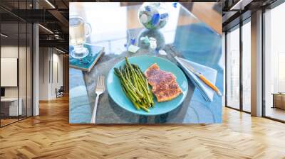 Keto lunch or dinner meal with seasoned cooked salmon, asparagus stalks and a carb-free drink Wall mural