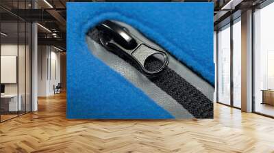 Black zipper with reflectors of blue fleece jacket pocket Wall mural