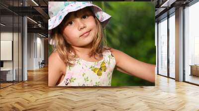 Cute European little girl in colorful Panama hat Wall mural