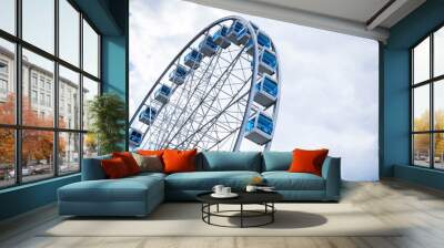 Ferris wheel on cloudy sky background Wall mural