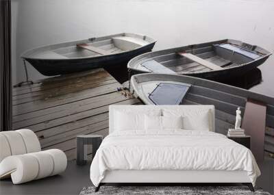 Three small row boats moored to wooden pier Wall mural