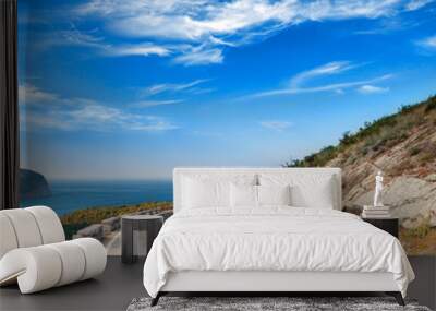 Turn of mountain highway with dramatic blue sky and sea Wall mural