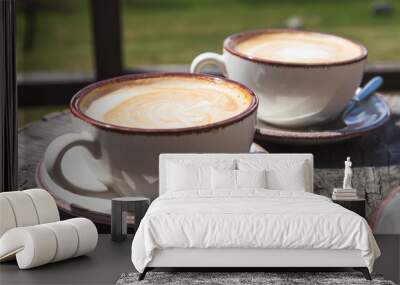 Two cups of cappuccino coffee in sunlight Wall mural