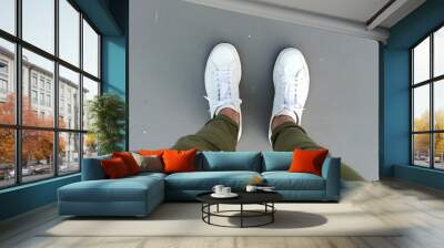 Urban Step. A pair of white sneakers on a concrete surface, viewed from above. Wall mural