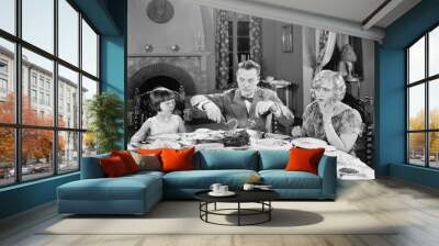 Family of three sitting together having dinner  Wall mural