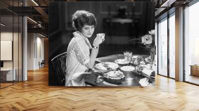 Portrait of woman eating meal at table  Wall mural