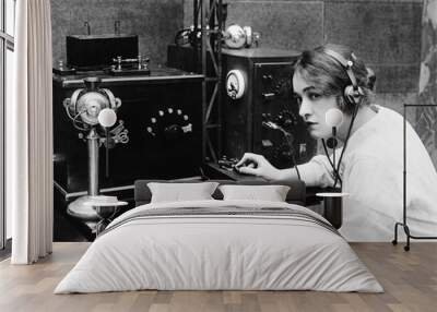 Woman sending Morse code using telegraph  Wall mural