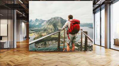 Adventurer man with red backpack enjoying mountains scenery Travel Lifestyle adventure vacations traveler standing alone on Rampestreken viewpoint in Norway Wall mural