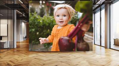 Child girl giving organic beet healthy food vegan eating lifestyle eco bio vegetables from garden home grown plant based diet nutrition Wall mural