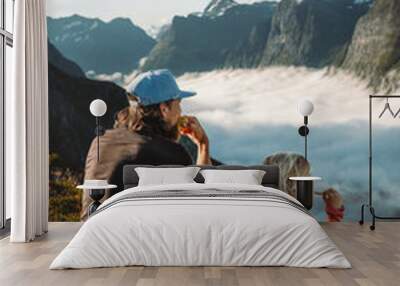 Family camping in mountains travel vacations father and daughter eating snacks outdoor dad with child hiking together active adventure tour in Norway picnic above clouds Wall mural