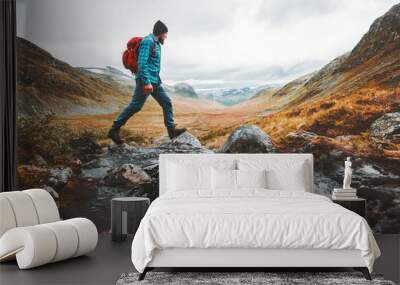 Man solo traveling backpacker hiking in scandinavian mountains active healthy lifestyle adventure journey vacations Wall mural