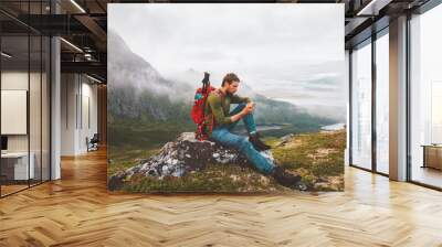 Man using smartphone hike in mountains travel blogger influencer lifestyle adventure vacations summer tour outdoor in Norway Wall mural