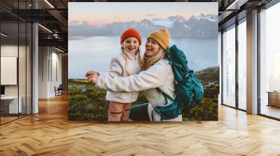 Mother and child daughter laughing having fun outdoor family hiking together travel lifestyle active vacations, woman with backpack playing with kid in mountains candid emotions, Mothers day holiday Wall mural