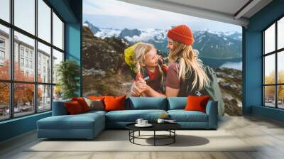 Mother and daughter hikers having fun in Norway mountains travel together active healthy lifestyle family vacations woman playing with child Mother's day holiday Wall mural