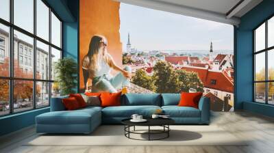 Woman sightseeing Tallinn city landmarks  vacations in Estonia travel lifestyle girl tourist relaxing at viewpoint Old Town aerial view architecture Wall mural