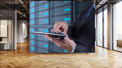 businessman using tablet computer and server room background Wall mural