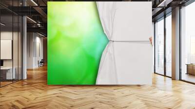 hand open crumpled paper to show green nature background as co Wall mural