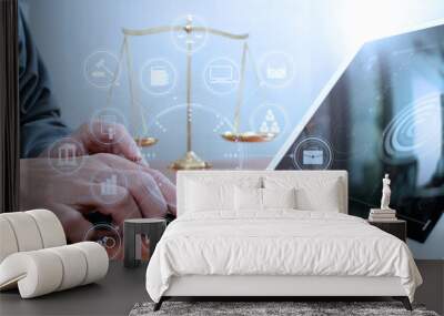 justice and law concept.Male lawyer in office with the balance brass scale,hand working with smart phone and digital tablet computer on wooden desk,virtual graphic icons screen diagram Wall mural