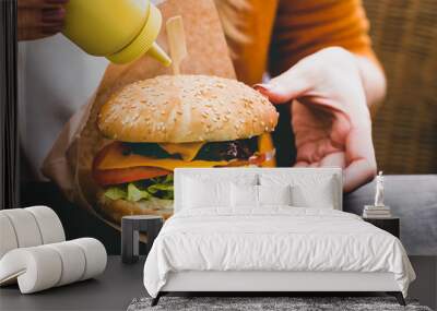 Fresh delicious burger with french fries on the black wooden table Wall mural