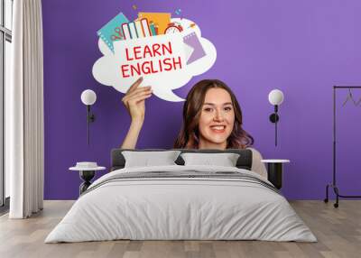 student girl holding speech bubble with text learn english and illustration isolated on lilac background Wall mural