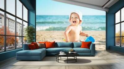 Baby playing at the sea Wall mural