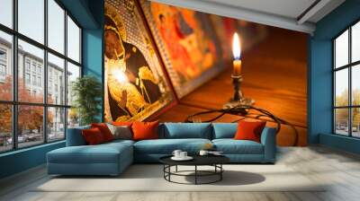 burning candle in a dark room, orthodox Wall mural