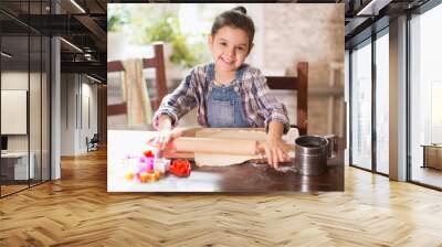 The girl rolls the dough for cookies Wall mural