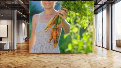 woman with a bunch of carrots Wall mural