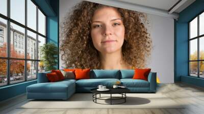 Young woman with curly hair Wall mural