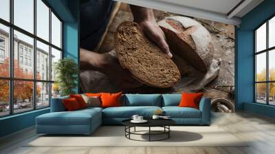 The Baker's hands hold a loaf of rye bread Wall mural