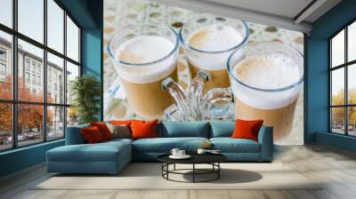 Glass glasses of delicious coffee with foam stand on table. Wall mural