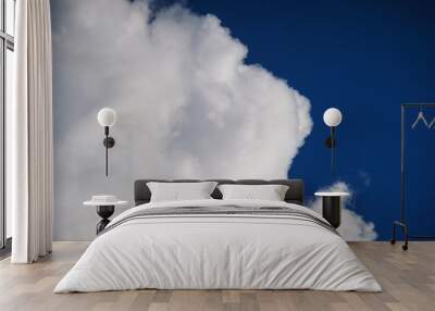 Large white cumulus clouds against a blue sky. Wall mural