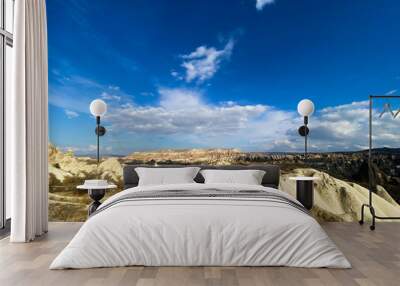 View of a valley filled with ancient rock formations. Blue sky, white clouds. Landscape. Cappadocia, Turkey. 5 november 2019 Wall mural