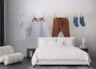 Baby clothes hanging on the rope. Wall mural