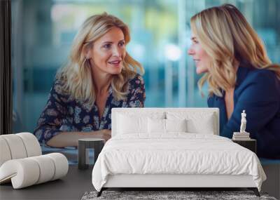 A smiling mature professional middle-aged business woman holds a meeting with her client sitting at a large table in a bright and spacious office Wall mural