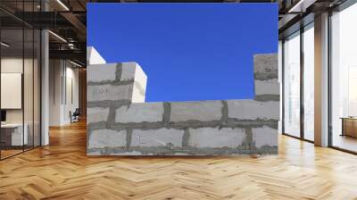 concrete blocks. wall of a house under construction from concrete blocks on a background of blue sky Wall mural