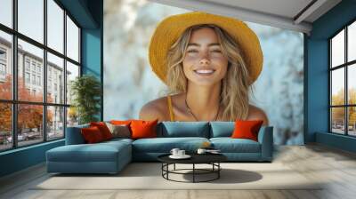 beautiful young woman with long blond hair in a yellow hat and swimsuit smiling at the camera Wall mural